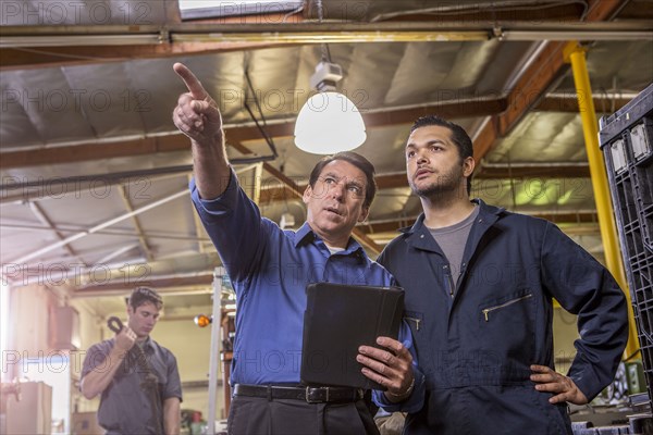 Worker and manager talking in warehouse