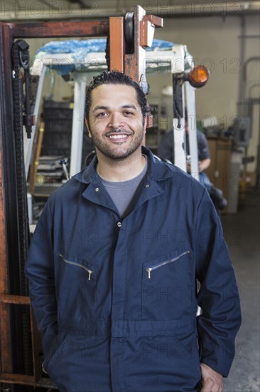 Hispanic worker smiling in warehouse