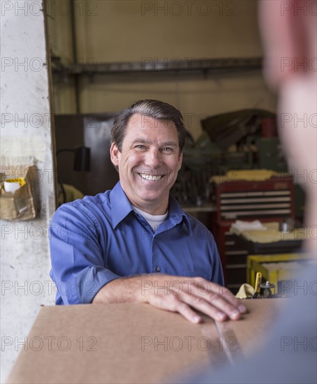 Caucasian workers smiling in warehouse