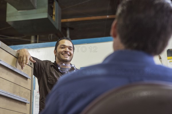 Worker and manager talking in warehouse