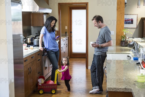 Family relaxing in kitchen