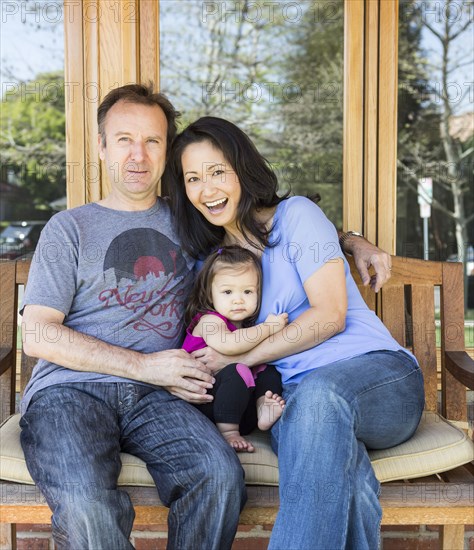 Family relaxing together on porch