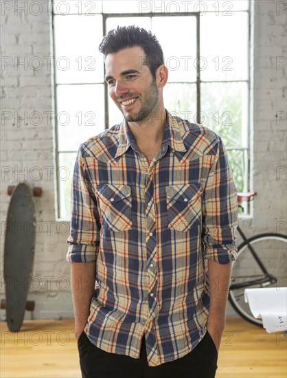 Caucasian man smiling in loft