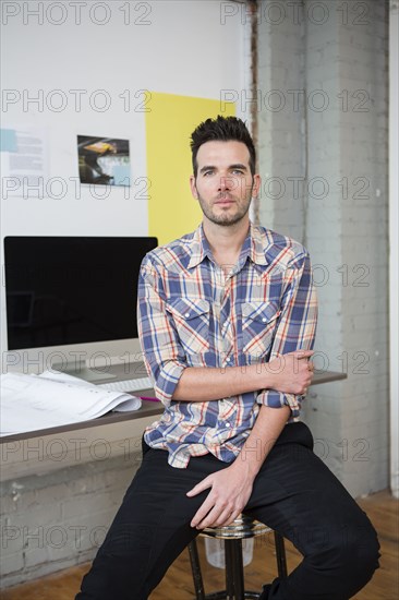 Caucasian architect sitting in office