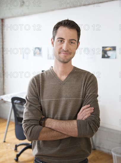 Caucasian architect smiling in office