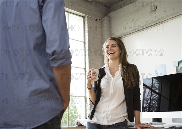 Caucasian architects drinking coffee in office