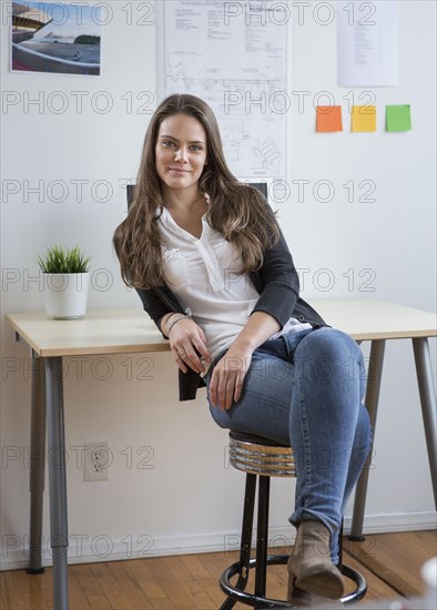 Caucasian architect smiling in office