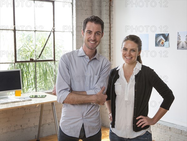 Caucasian architects smiling in office