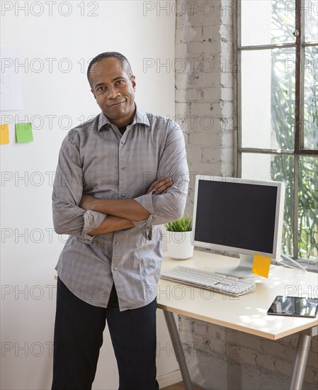 African American architect smiling in office