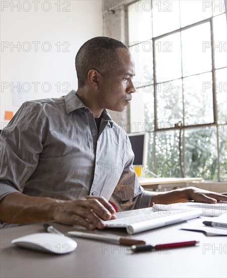 African American architect working in office