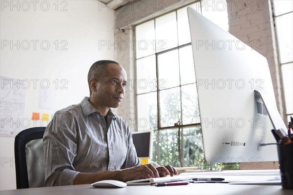 African American architect working in office