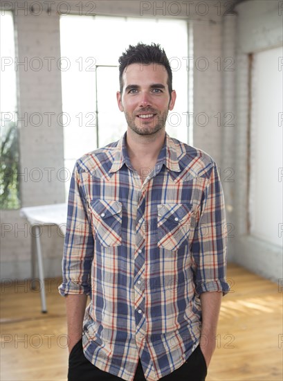 Caucasian architect smiling in office