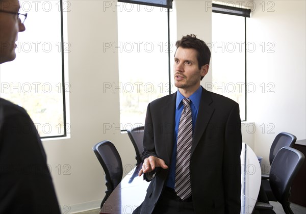 Businessmen talking in office