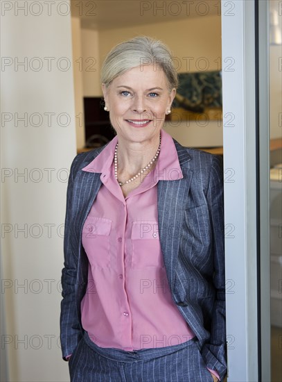 Caucasian businesswoman smiling in office