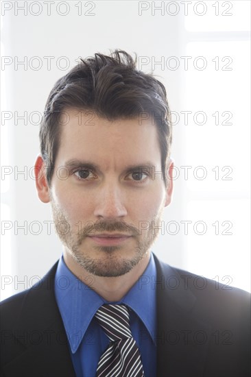 Close up of mixed race businessman's face