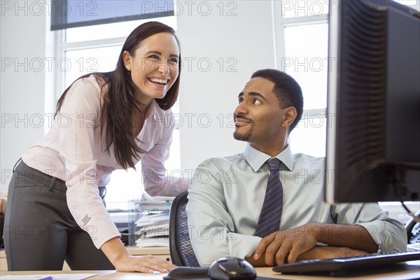 Business people working together at computer in office