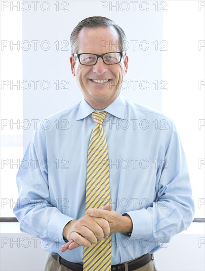 Caucasian businessman rubbing his hands in office