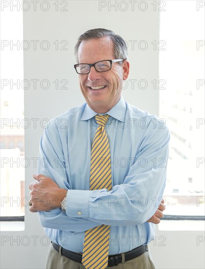 Caucasian businessman smiling in office