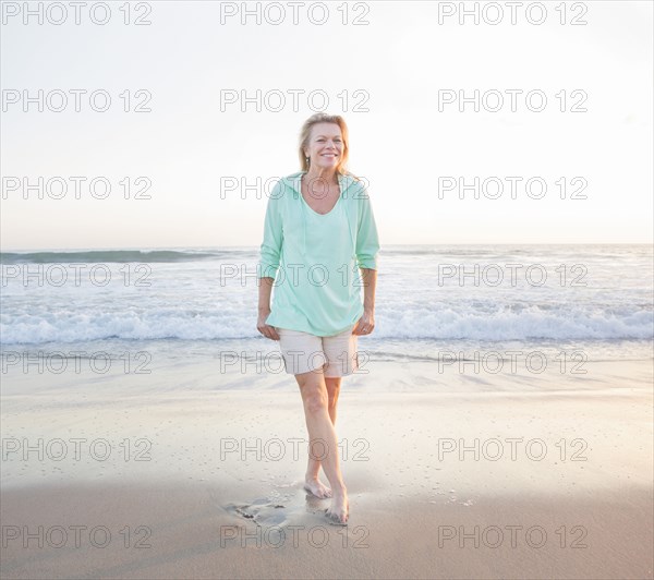 Caucasian woman smiling on beach