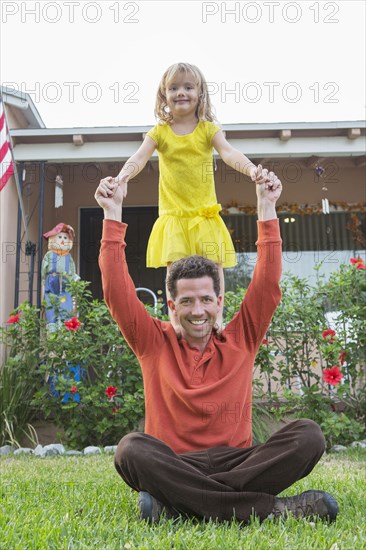 Caucasian father and daughter playing in backyard