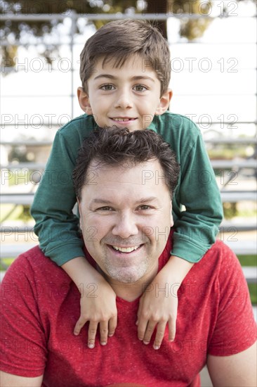 Caucasian father and son playing on bleachers