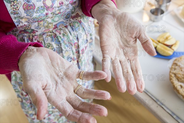 Close up of flour on hands of older Caucasian woman