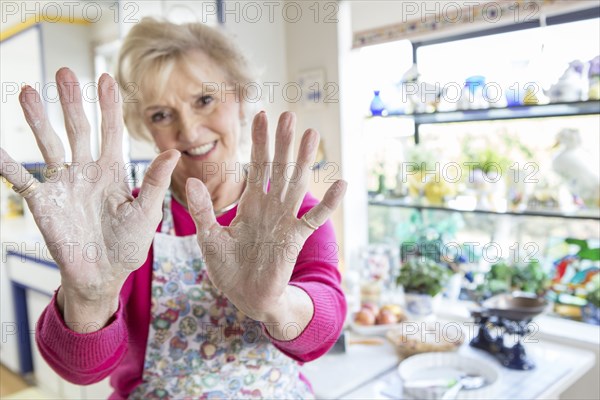 Close up of flour on hands of older Caucasian woman