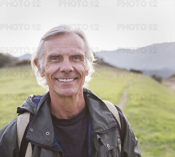 Older Caucasian man walking on dirt trail