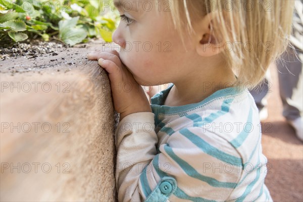 Close up of Hispanic boy playing in garden