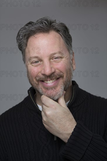 Close up of Caucasian man scratching his chin