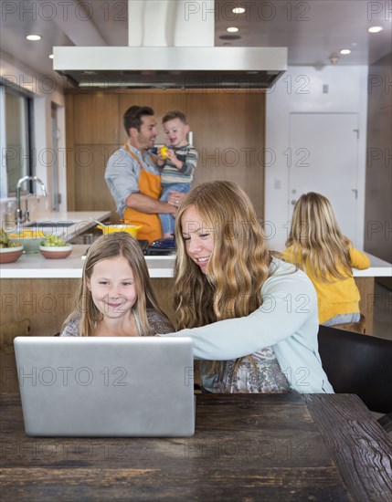 Caucasian family relaxing in kitchen