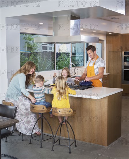 Caucasian family cooking in kitchen