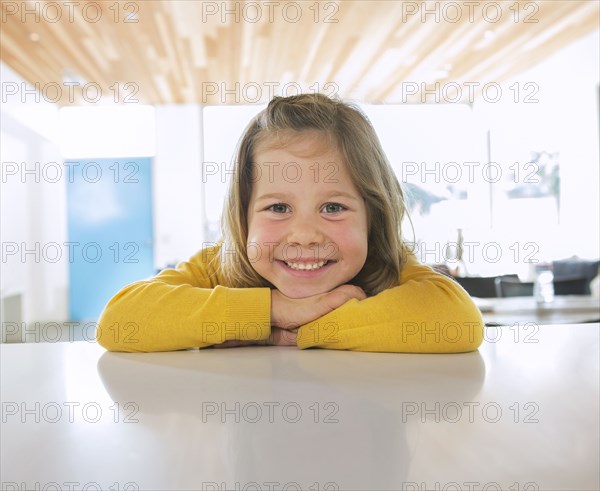 Caucasian girl smiling on counter