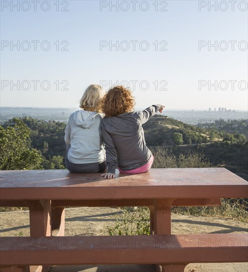 Caucasian women admiring scenic view from hilltop