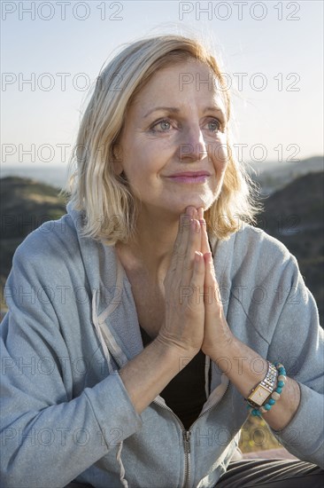 Close up of Caucasian woman with hands clasped