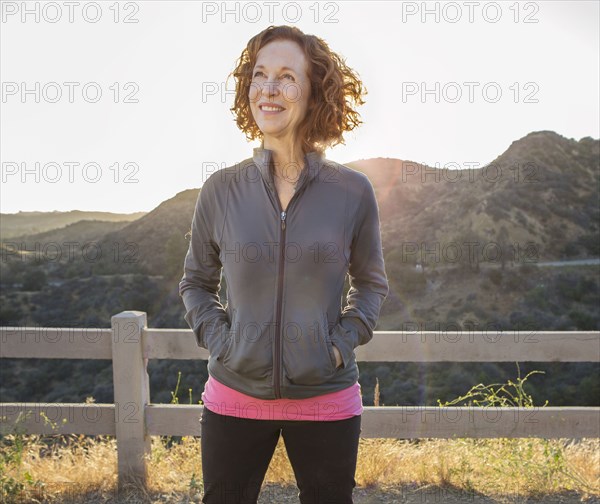 Caucasian woman smiling on hilltop