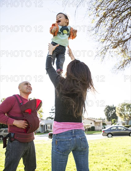 Low angle view of Hispanic family playing in park