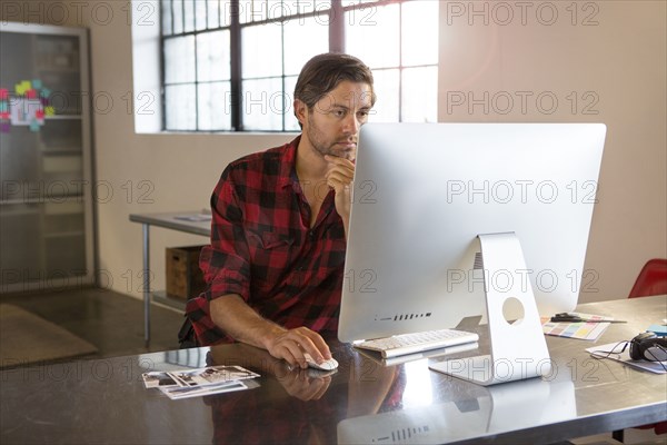 Caucasian businessman using computer in office