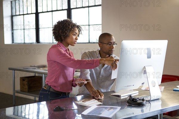 Business people using computer in office