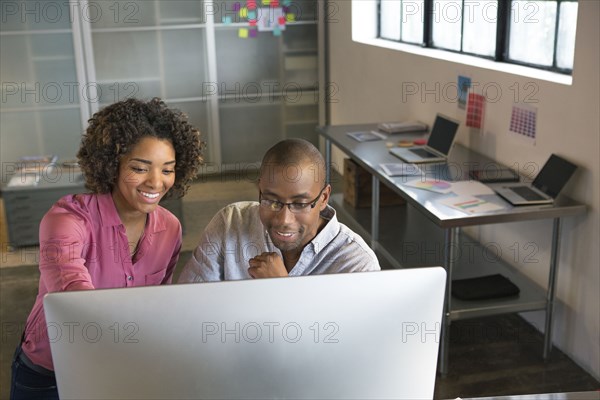 Business people using computer in office