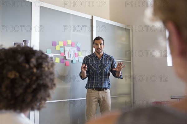 Businessman talking to colleagues in office meeting