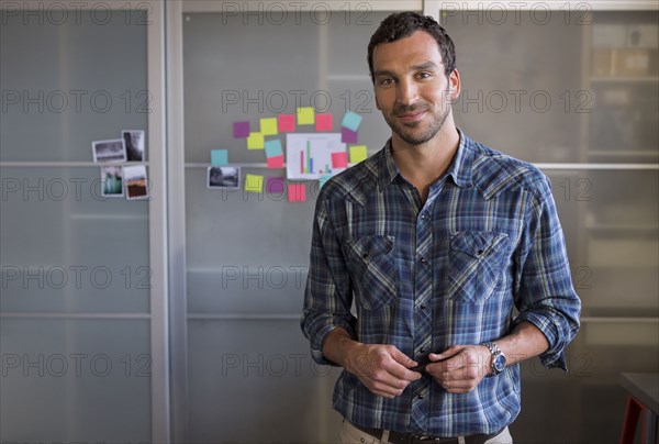 Caucasian businessman smiling in office