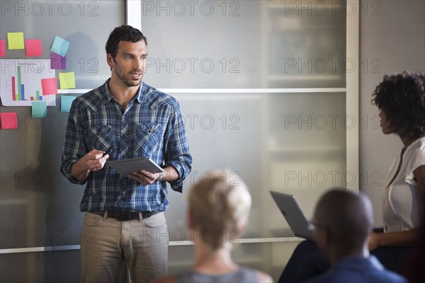 Businessman talking to colleagues in office meeting