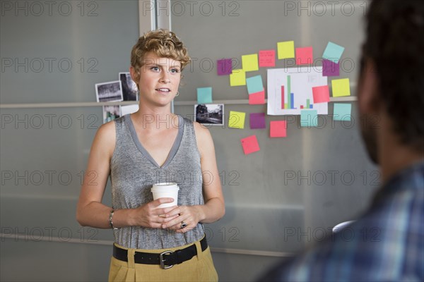 Businesswoman talking to colleague in office