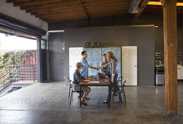 Business people shaking hands in office meeting