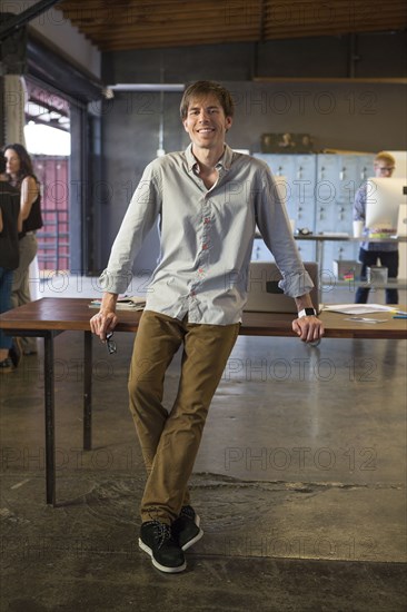 Caucasian businessman smiling in office