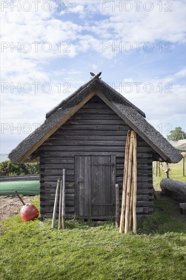 Wood shed under clouds