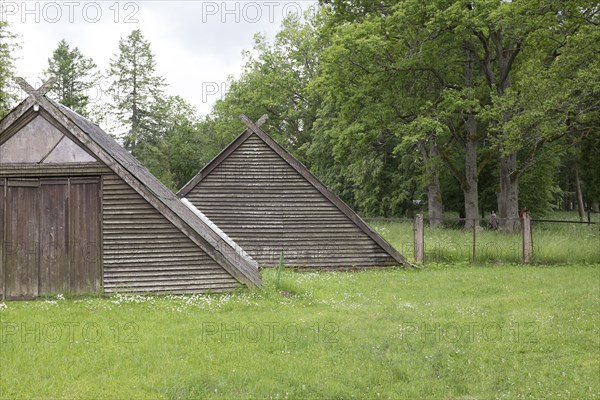 Traditional wooden buildings in field