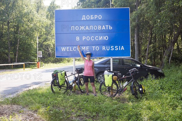 Hispanic biker cheering at Russian border