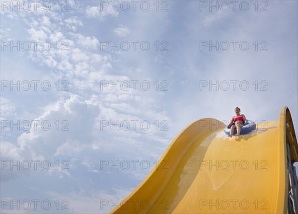 Hispanic woman on water slide